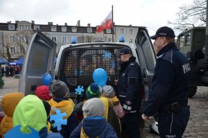 Policjanci pokazują radiowóz dzieciom