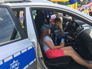 Policjanci w trakcie pikniku pokazują sprzęt dzieciom