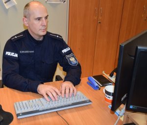 Policjant siedzi przy biurku