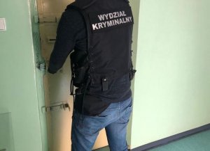 Policjant prowadzi zatrzymanego