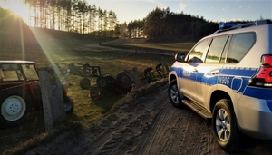 policjanci pracowali na miejscy zdarzenia, w którym wywrócił się ciągnik rolniczy
