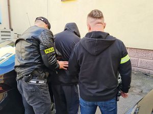 policjant prowadzi zatrzymanego