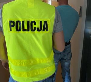 policjant z zatrzymanym mężczyzną