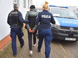 policjanci prowadzą zatrzymanego