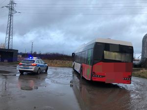 policjant wraz zatrzymanym, tester narkotykowy i autobus wraz z radiowozem