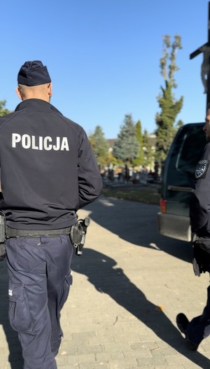 Policjanci z powiatu puckiego rozmawiają o zasadach bezpieczeństwie z odwiedzającymi groby przed Dniem Wszystkich Świętych.